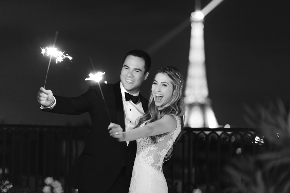 Couple on wedding day holding sparklers in hands